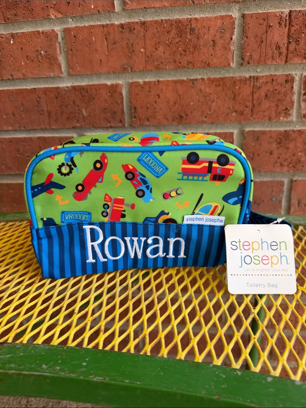Stephen Joseph Boy Transportation Toiletry Bag with Rowan Embroidered on it.
